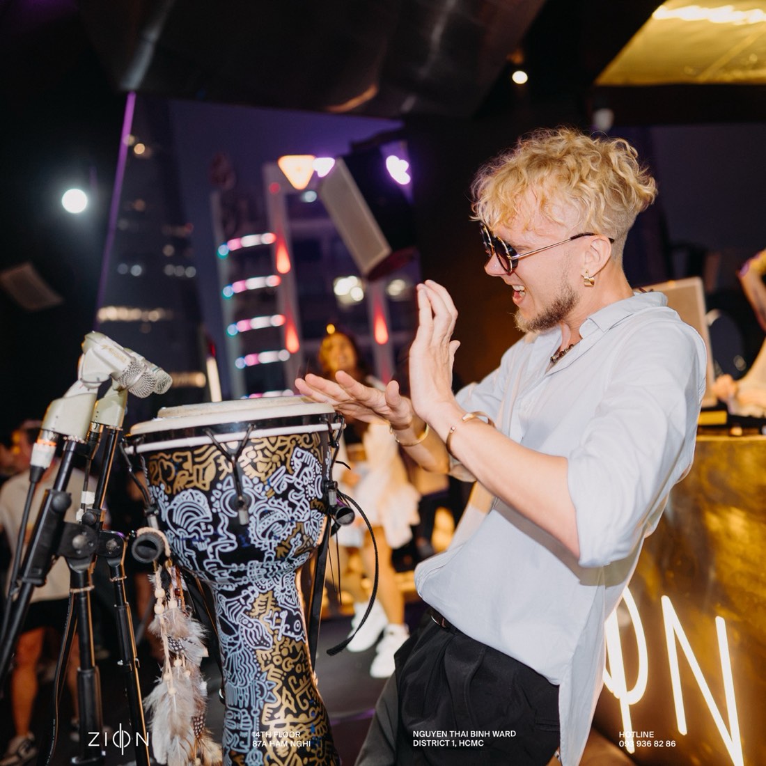 Manooson playing djembe on stage